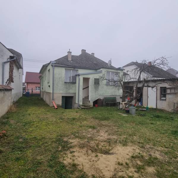 A family house in Malé Leváre with a garden and a pitched roof.