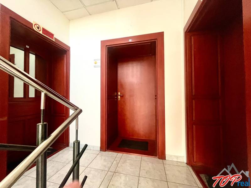 Offices with brown doors, stairs, and white walls.