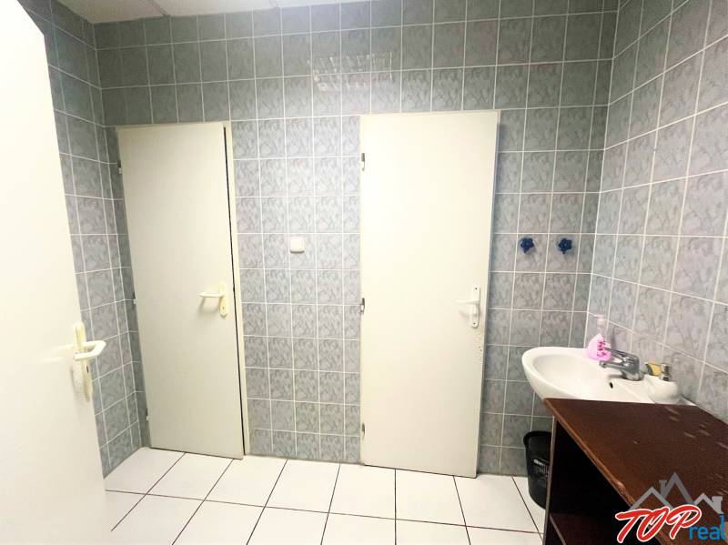 Bathroom with a sink, tiles, and white doors.