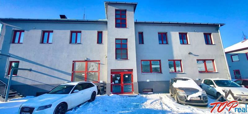 The facade of the office on Osloboditeľov in Košice - Barca district, cars parked on a snowy area.