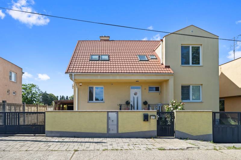 A family house on Tehelná Street in Sereď with a red roof and yellow facade.