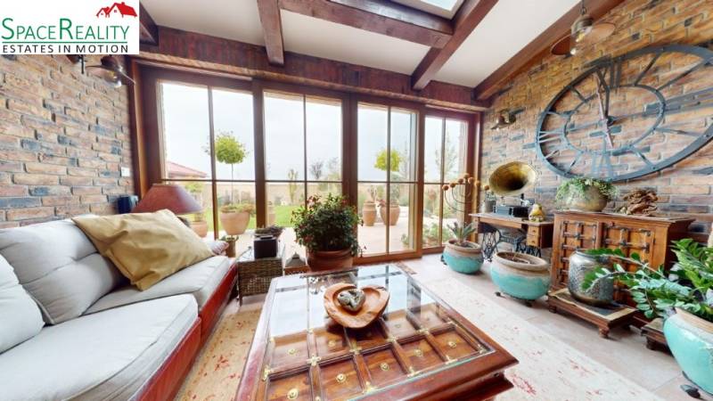 Interior of a family house with historical decorations and large windows, floor with wooden decor.