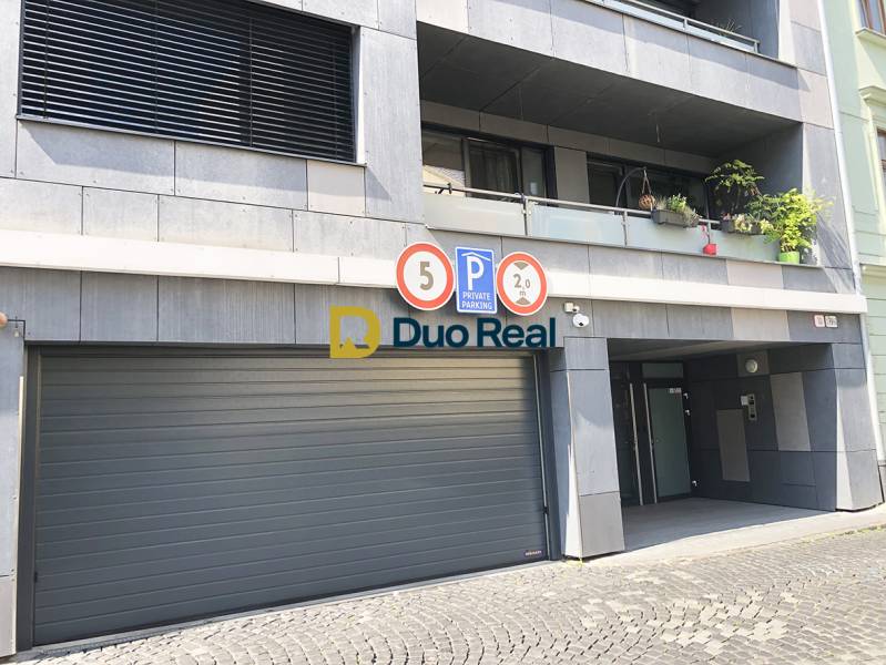 Garages on Jozefská Street in Bratislava - Old Town with warning signs.