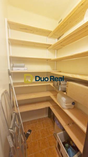 Pantry with shelves and stored items in a 3-room apartment.