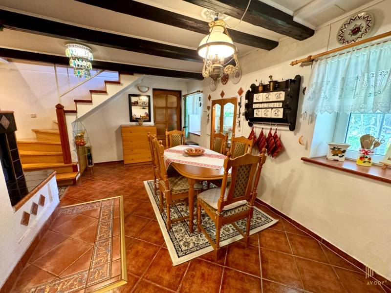 Dining room in a family house with wooden decor, decorated with rustic furniture and details.