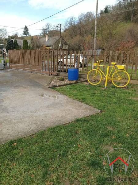 Yellow bicycle and fence on the property in Jasenovce, Jesenovce Street, Land - residential.