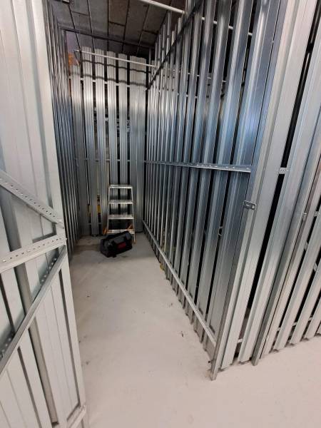 Storage space with metal walls and tools, suitable for a studio apartment.