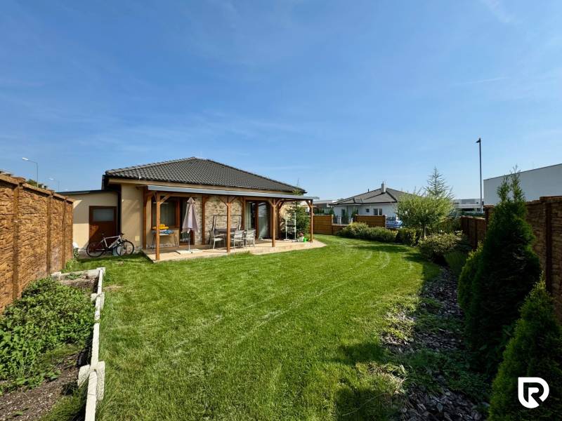 Garden at a family house on Pod privádzačom Street in Trenčín with a lawn and a gazebo.