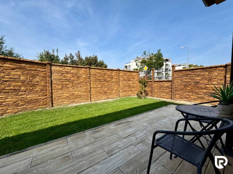 The garden of a family house in Trenčín on Pod privádzačom street with a stone fence and a terrace.