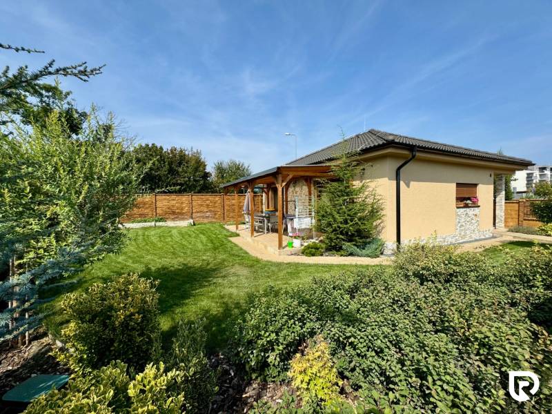 A family house on Pod privádzačom Street in Trenčín, surrounded by a landscaped garden and terrace.
