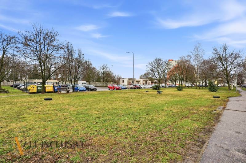 A view of the parking lot and surrounding trees in the town of Veľký Meder.