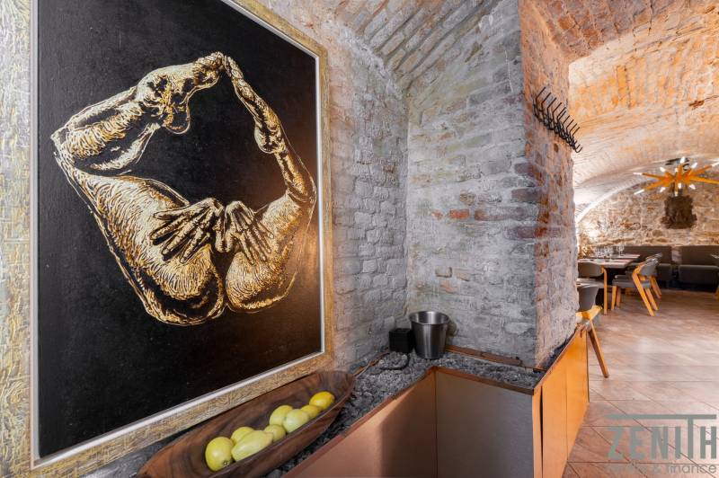 Interior with brick walls, artwork, tables and chairs, dining spaces.