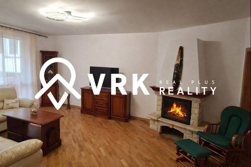 Living room in a 3-room apartment with a TV, fireplace, and wooden decor flooring.