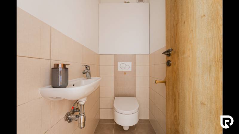A small bathroom in a 2-room apartment with a toilet and a sink.