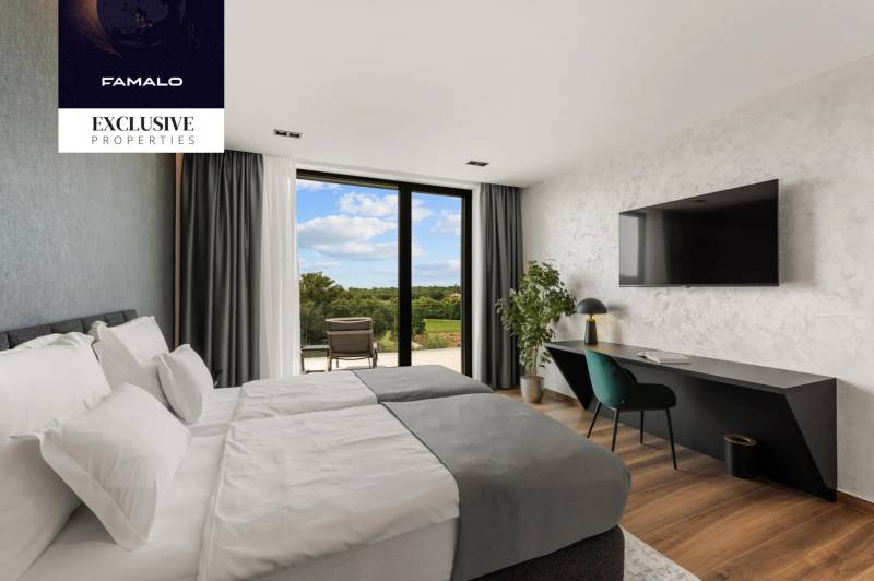 Stylish bedroom in a villa with large windows, a view, and a wooden decor floor.