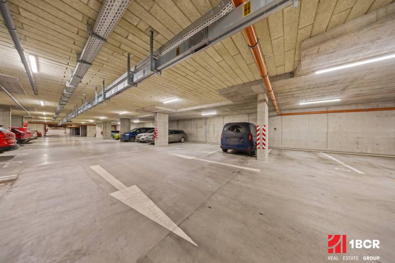 Underground parking on Rudroffova Street in Bratislava-Rača with several parked cars.