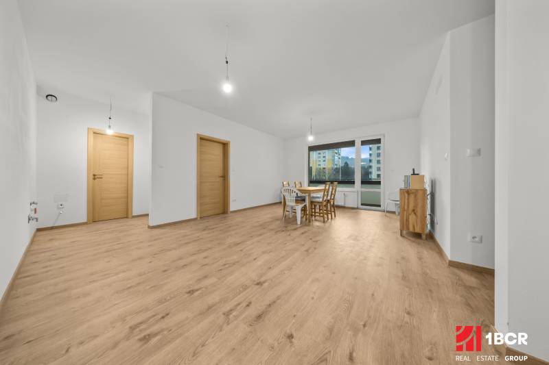 Living room in a 3-room apartment with a wooden decor floor and a dining table.