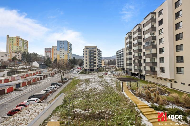 View of apartment buildings and parking spaces on Rudroffova Street in Bratislava - Rača.