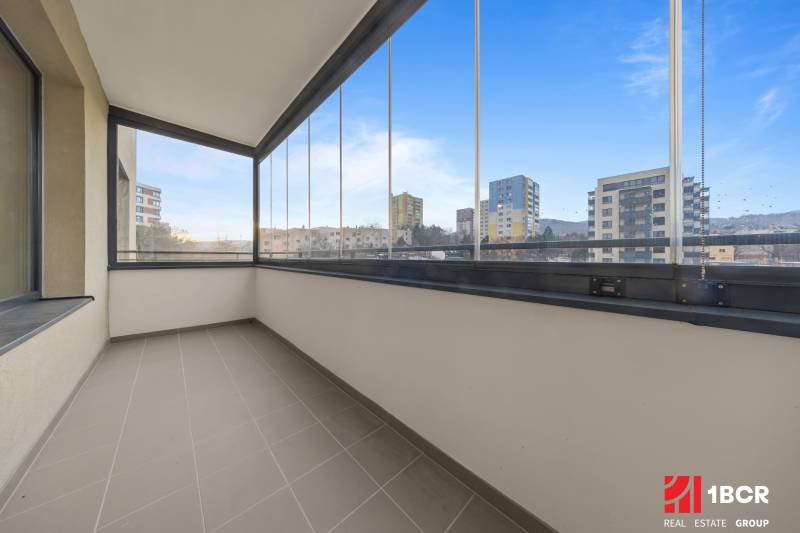 A glazed balcony of an apartment on Rudroffova Street in Bratislava-Rača with a view of the surroundings.