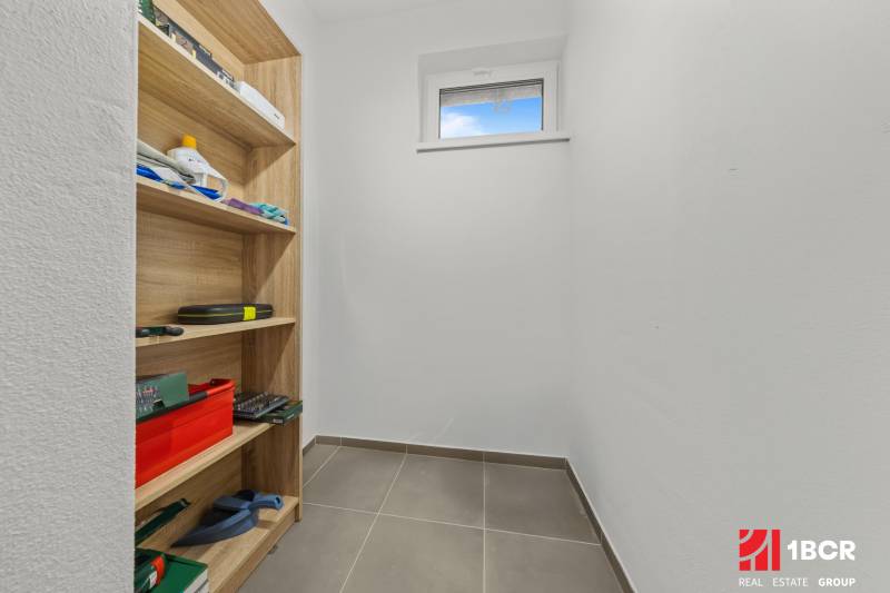 Storage space with shelves and a window in a 3-room apartment.