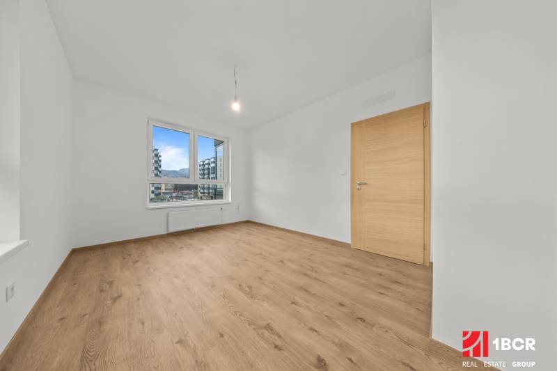 A room with a wooden floor decor, a window, and wooden doors, a 3-room apartment.