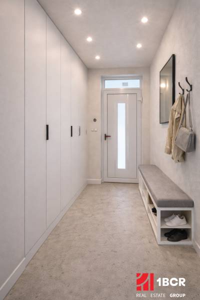A hallway in a family house with a coat rack, a bench, and a built-in wardrobe.