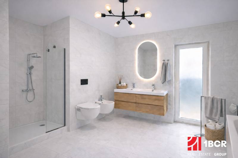 Elegant bathroom with a large mirror and a shower in a family house.