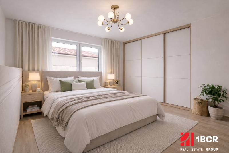 Bright bedroom in a family house with wood-decor flooring and a large bed.