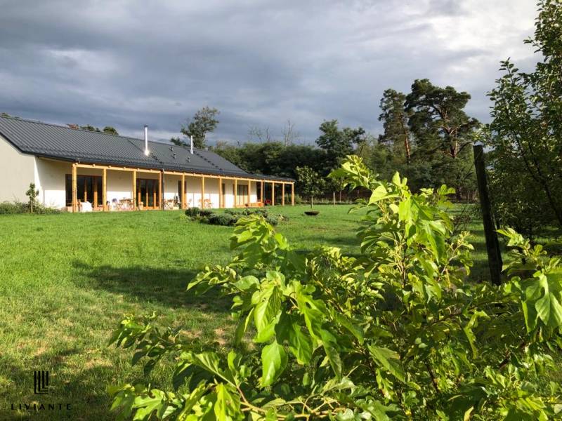 A building in the village of Láb on Láb Street surrounded by a large garden and greenery.