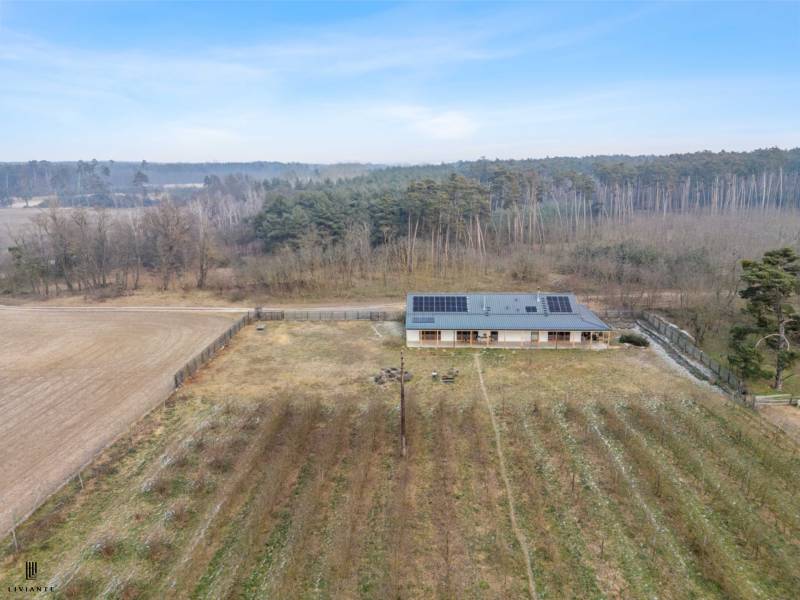 A building with photovoltaic panels on the roof in the middle of nature in the town of Láb.