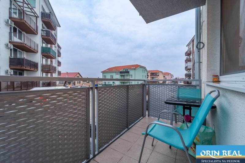 Balcony on Slavomírova Street in Slovenský Grob with a view, chairs, and a table.