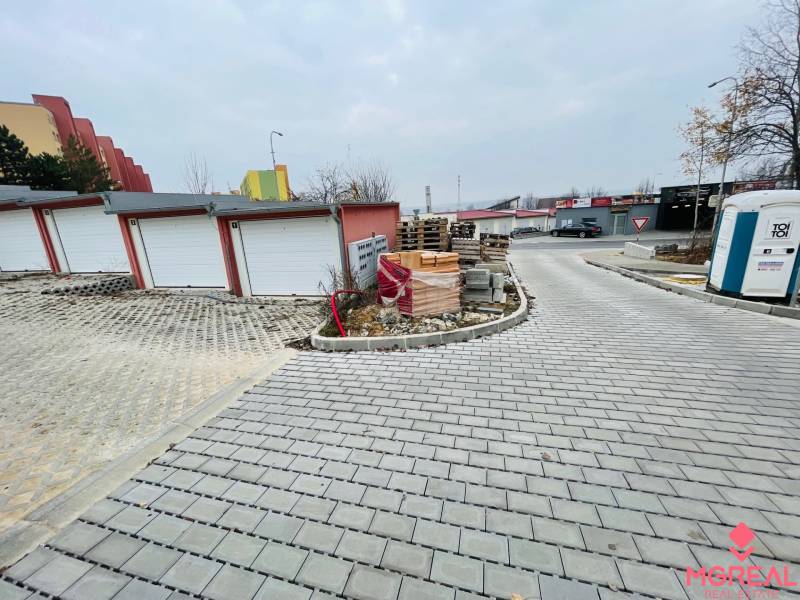 Rázdolie Street in Malé Uherce shows garages next to newly laid paving.