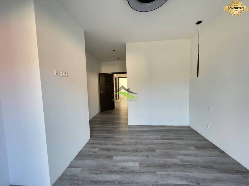 Interior of a family house with a wooden decor floor and white walls.