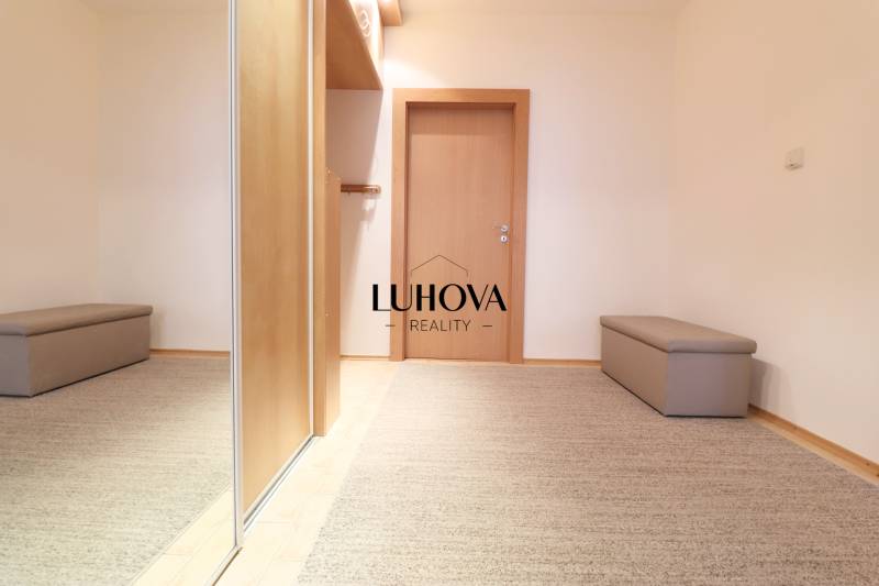 Interior of a 3-room apartment with carpet, mirrored wardrobe, and wooden doors.