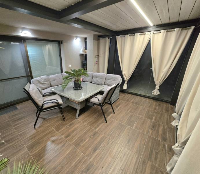 Interior of a family house with a corner seating area, table, and floor with a wood decor.