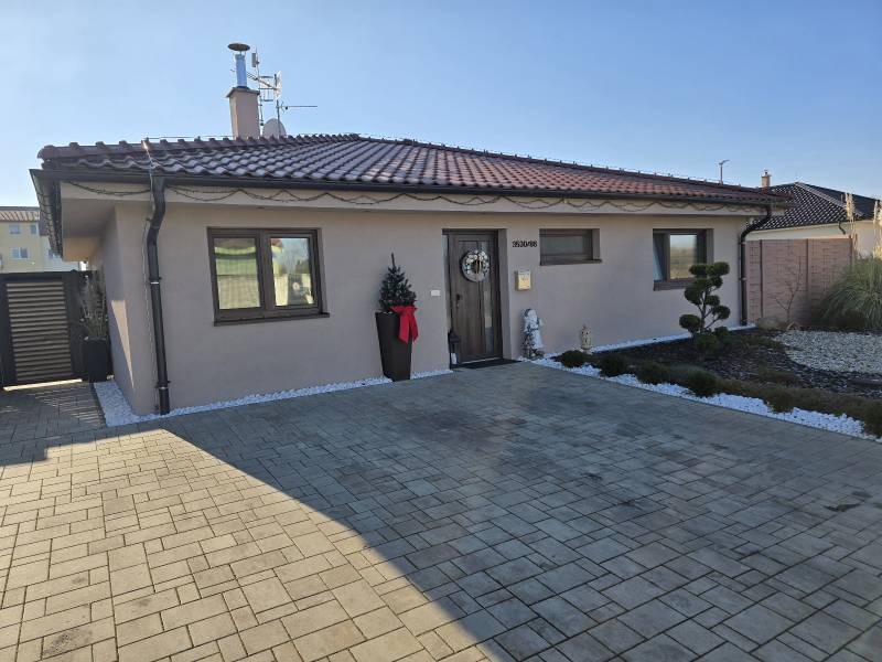 A family house on M. Terézie Street in Holíč with a neatly maintained front garden.