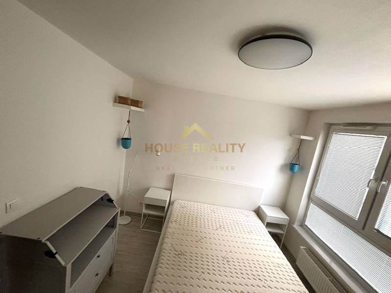 Bright bedroom with bed and furniture, 2-room apartment, floor with wood decor.