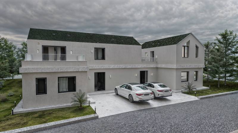 A family house in Mlynica with two white cars in the driveway.
