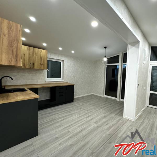 A kitchen unit with a wooden decor floor in a family house.