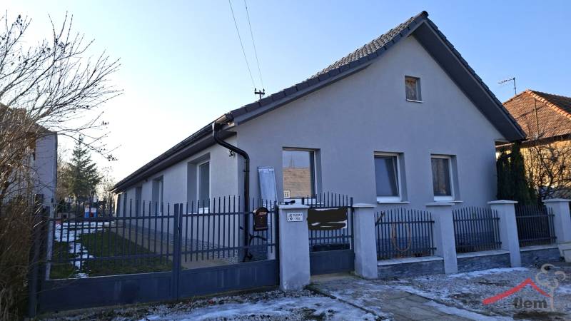 A family house in Žitavce on Žitavce Street with a front fence and a winter garden.