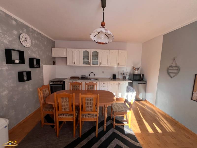 A kitchen in a family house with wooden furniture and a floor with a wooden decor.