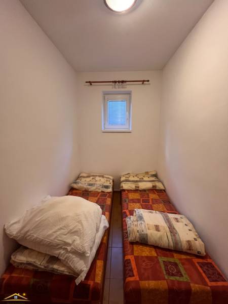 A cozy room with two beds in a family house.