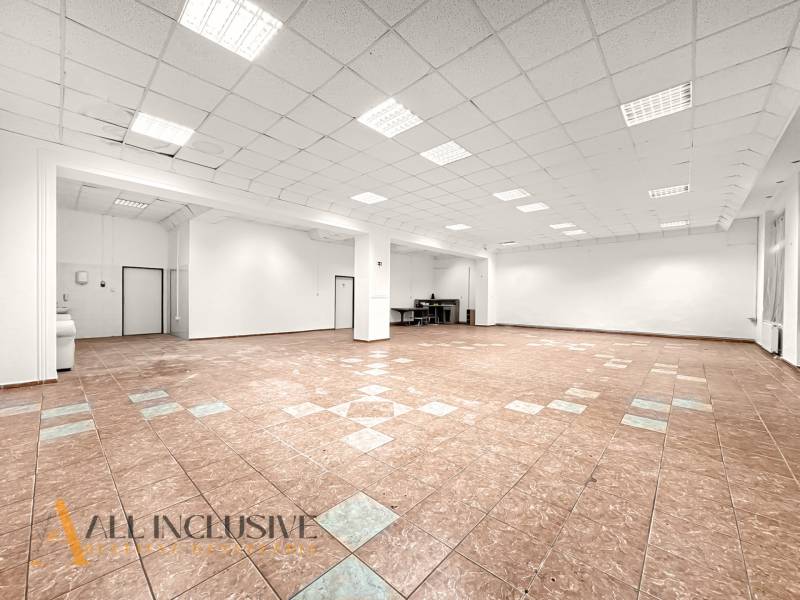 Spacious commercial premises with ceramic tiles and white walls.