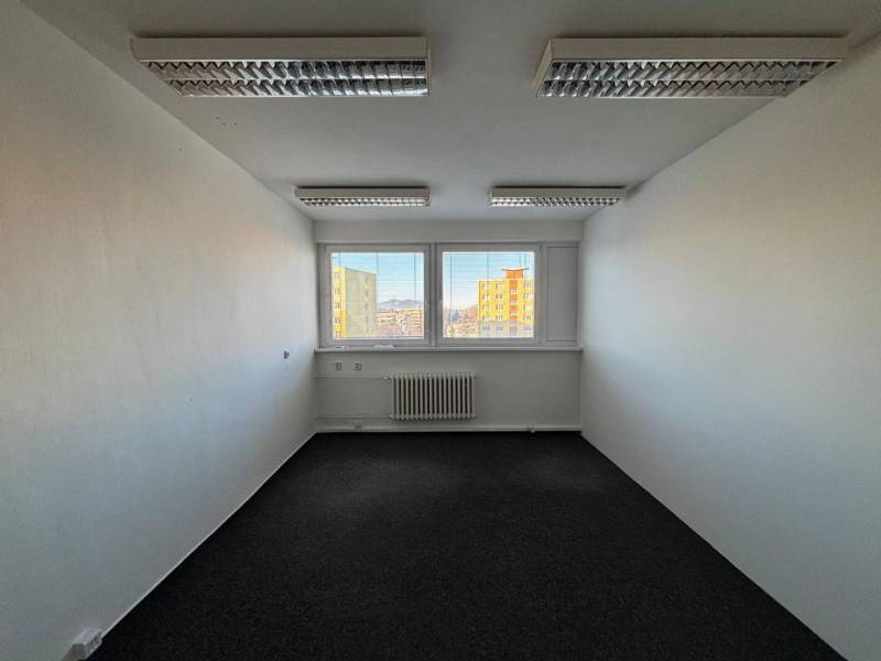 A bright office with skylights and a view of the buildings of Poprad.