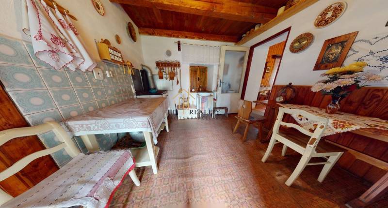 A kitchen in a family house with rustic furniture and decorations on the walls.