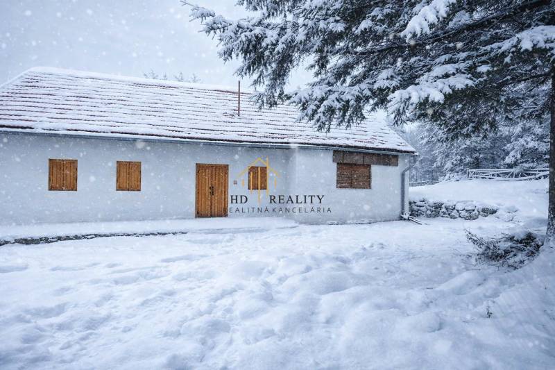 A family house on Stará Huta 84 street covered with snow in a winter landscape.