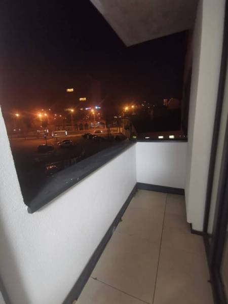 The balcony of a 2-room apartment with a view of the night panorama of Poprad.
