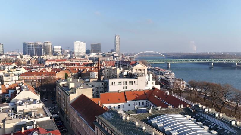 A view of the city skyline of Bratislava from Vajanského nábrežie with a bridge over the Danube River.