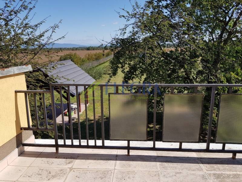 A balcony in a family house in Stretavka with a view of nature and a gazebo.