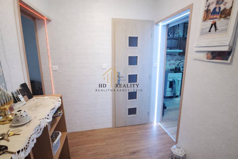 Interior of a family house with a wooden decor floor and white walls.
